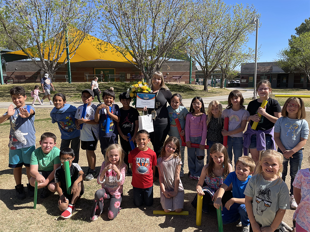 Teacher receiving Teacher Excellence Award with class